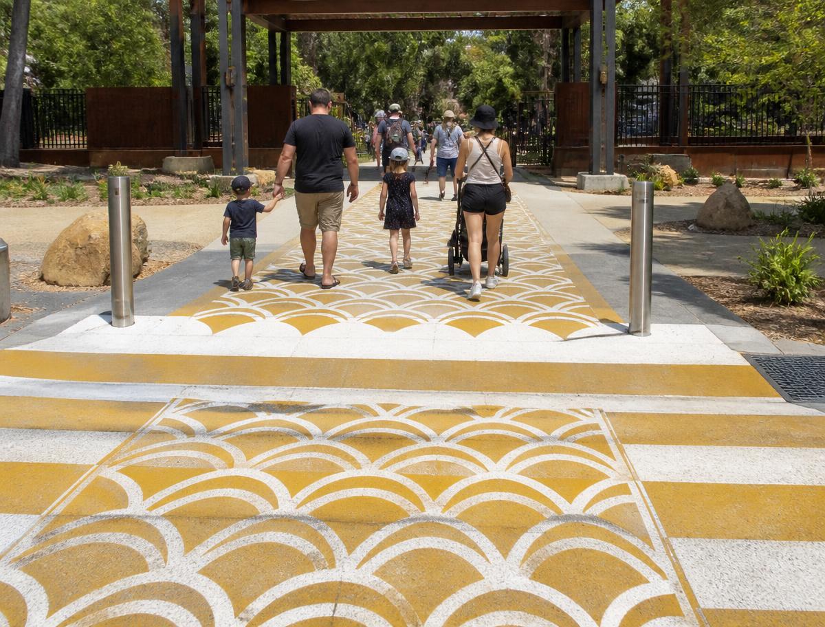 Patterned decorative pavement walkway leading into a public park
